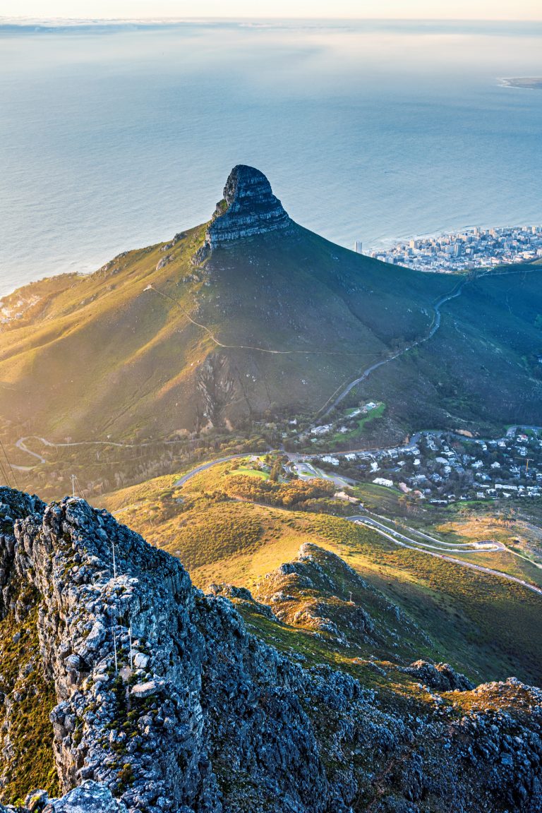 Lion’s Head mountain peak overlooking Cape Town with ocean views during golden hour.